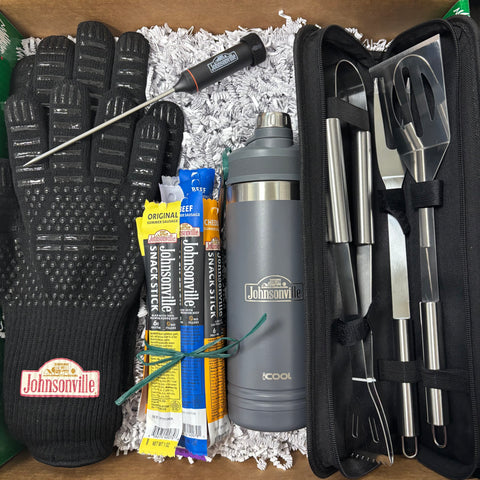 Barbecue set with gloves, thermos, and tools on a wooden surface