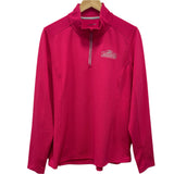 Pink long-sleeve shirt with a logo on a hanger against a white background