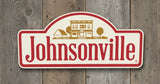 Outdoor kitchen with a Johnsonville-branded sign and a large barbecue grill.